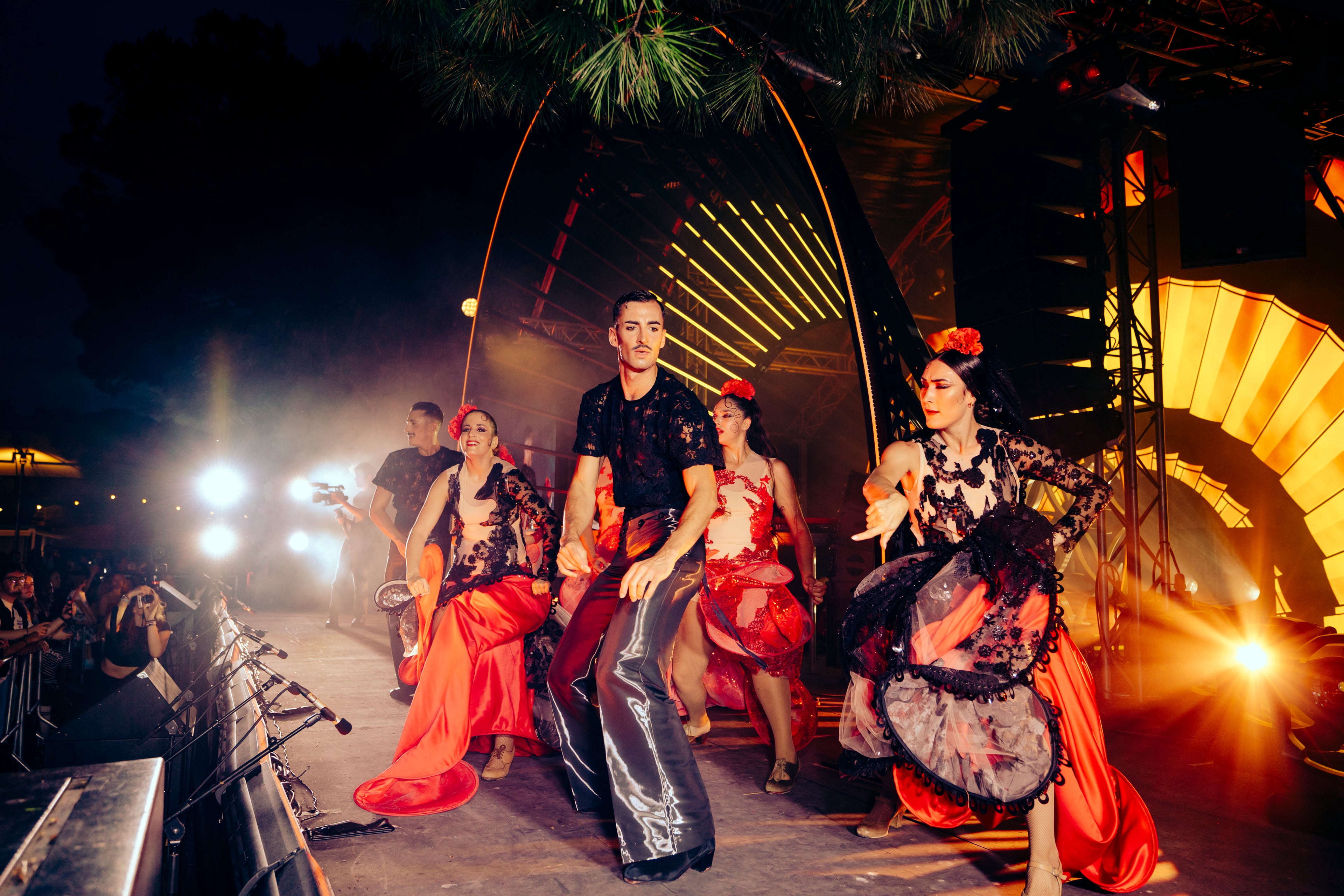 Dancers in traditional Flamenco costumes on a stage at FLAMENCA 